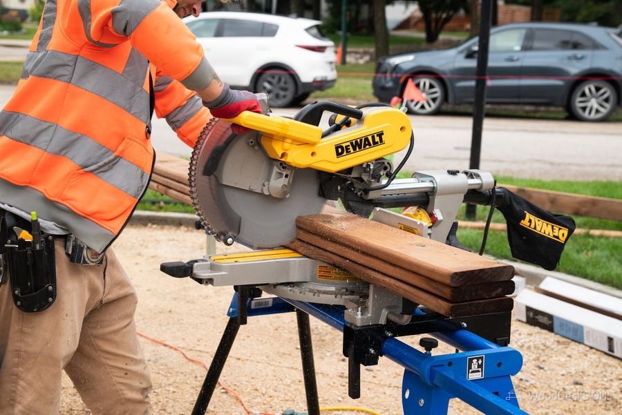 Cutting boards on a mitre saw on a WoodDeckS'ON fence project